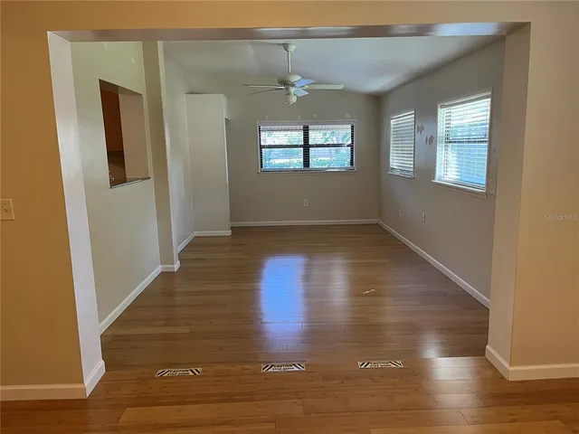 a living room with furniture a ceiling fan and a rug