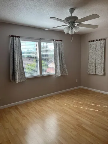 a bedroom with a bed flowerpot and window