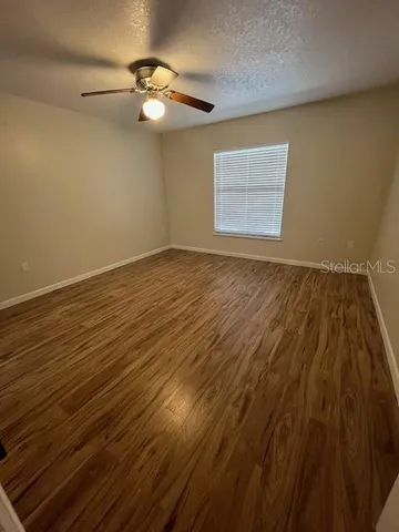a bedroom with furniture and a ceiling fan