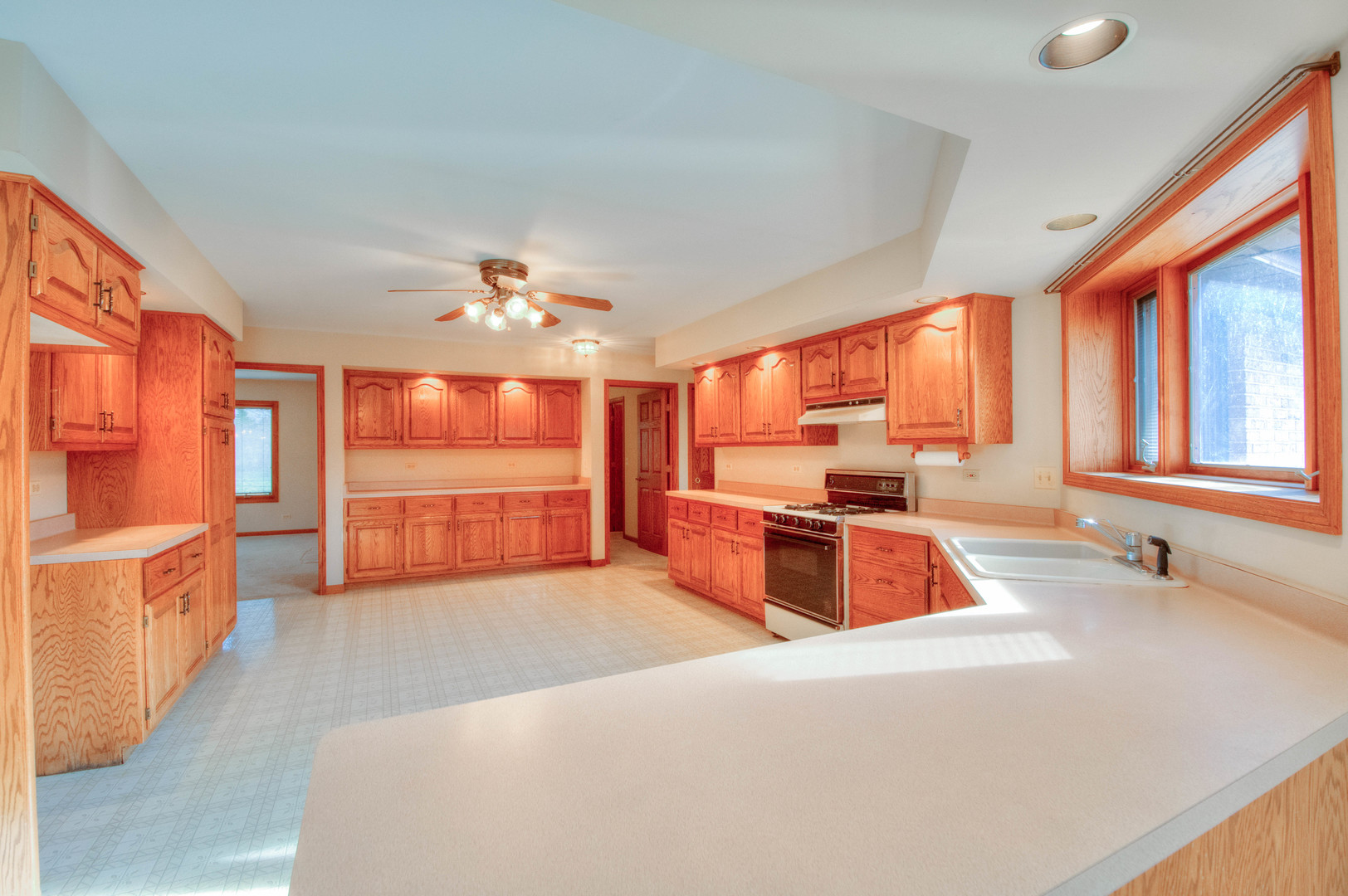 20501 Hebron Road Harvard, IL 60033 - Photo 16 of 49 a large kitchen with kitchen island a large counter space windows and a sink