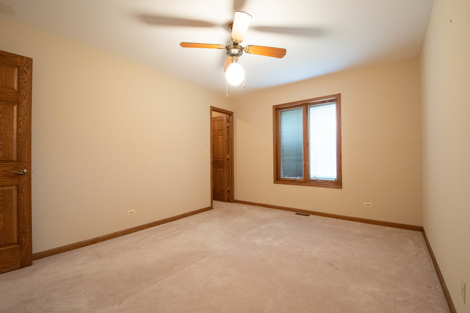 20501 Hebron Road Harvard, IL 60033 - Photo 29 of 49 an empty room with a chandelier fan and windows