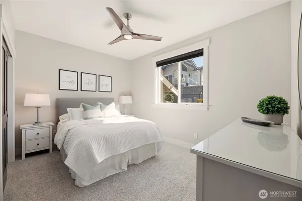 a bedroom with a bed and a potted plant