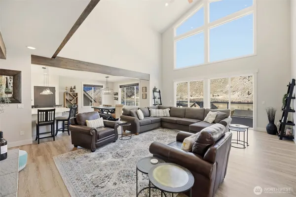 a living room with furniture wooden floor and a large window