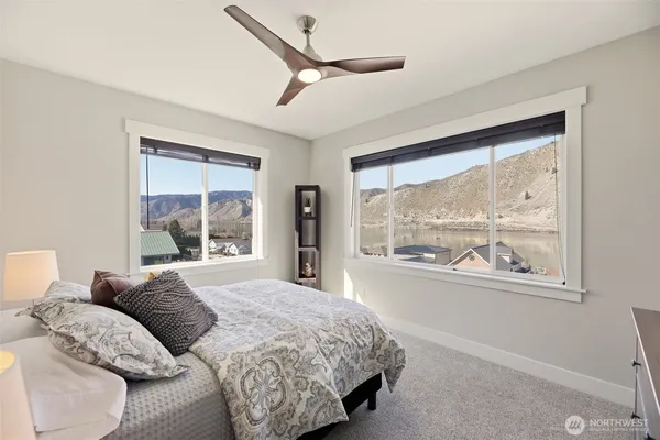 a bedroom with a large bed and a large window