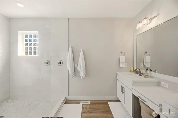 a bathroom with a sink a vanity and a mirror