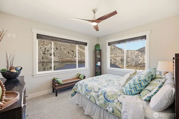 a bed sitting in a bedroom next to a window