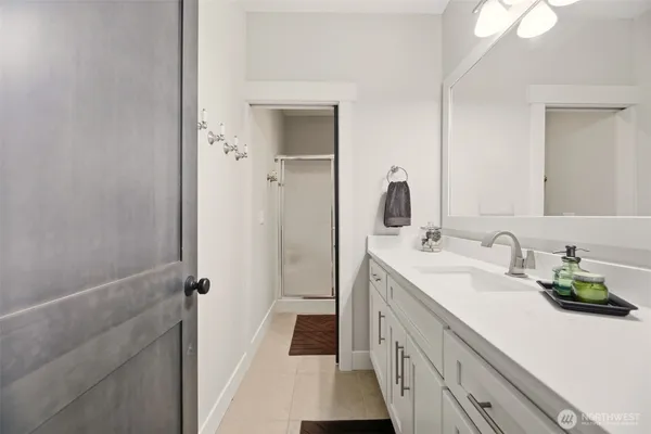 a bathroom with a double vanity sink and a mirror