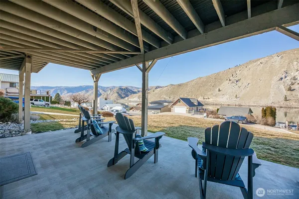 a view of a swimming pool with chairs in patio