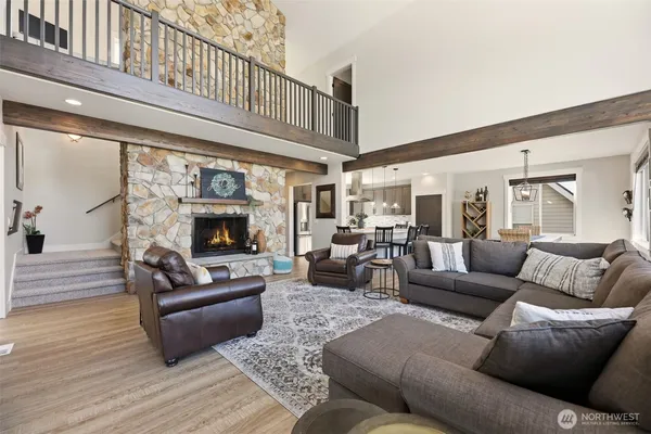 a living room with furniture wooden floor and a fireplace