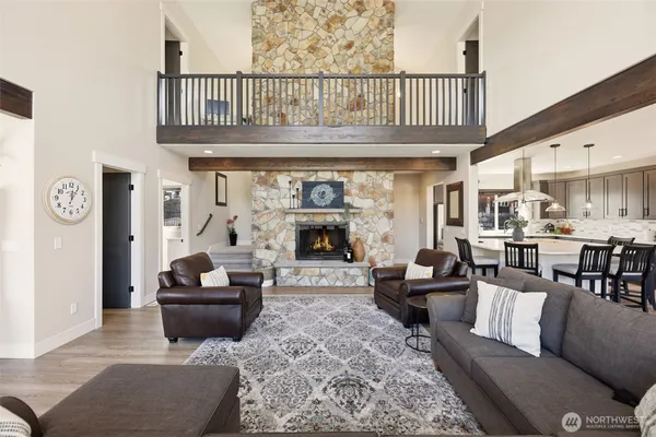 a living room with furniture a fireplace and a table
