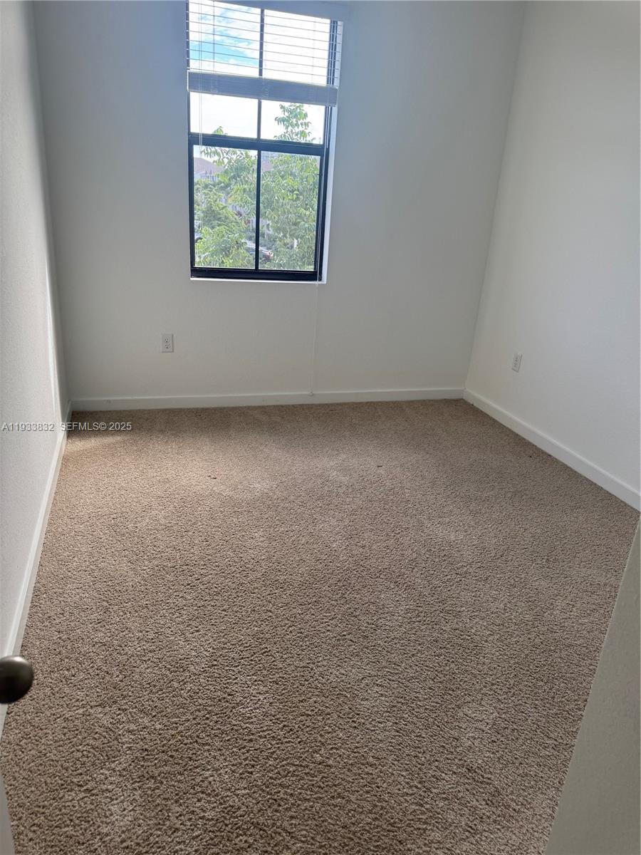 817 Northwest 3rd Way Pompano Beach, FL 33060 - Photo 11 of 13 an empty room with a window