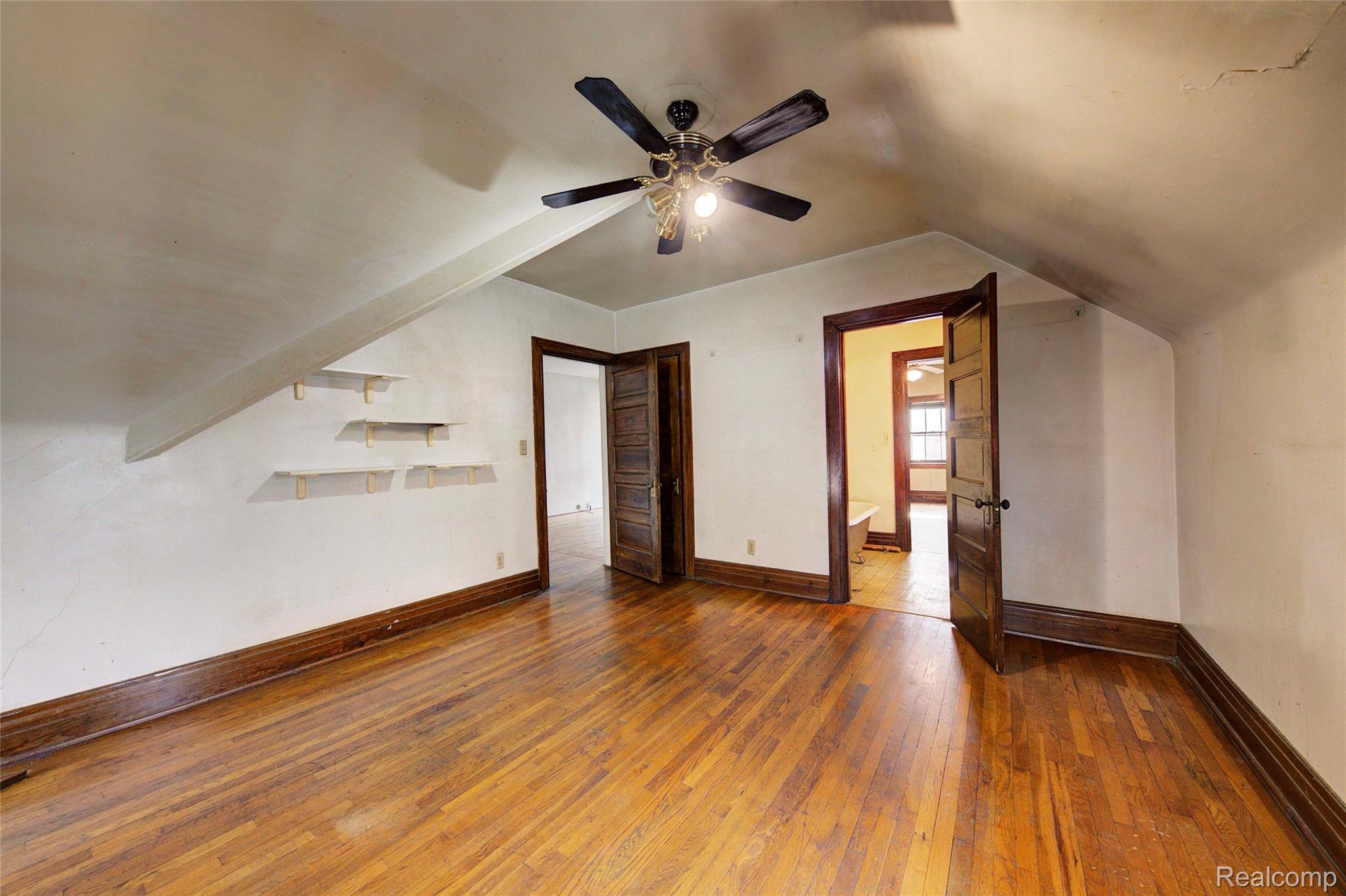 121 Longfellow Street Detroit, MI 48202 - Photo 64 of 87 Bonus room with dark wood finished floors, vaulted ceiling, and a ceiling fan
