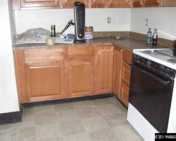 3743 Neil Road Reno, NV 89502 - Photo 4 of 6 a kitchen with granite countertop a sink and a stove