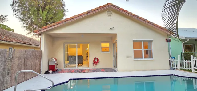 a bedroom with a bed and a flat tv screen on dresser