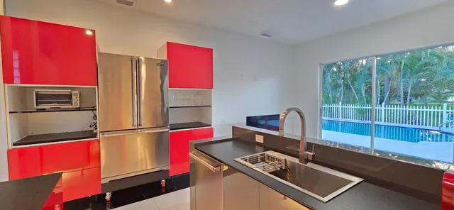 a view of a swimming pool with a patio and a garden