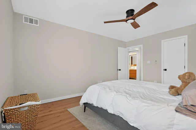 a bedroom with a bed and a ceiling fan