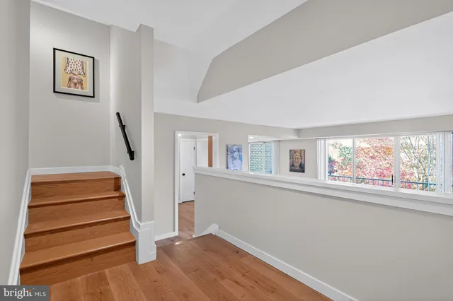 a view of entryway with stairs and wooden floor