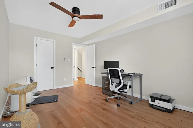a view of workspace with wooden floor windows