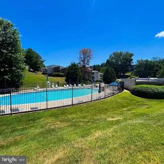 a view of front of house with yard and swimming pool