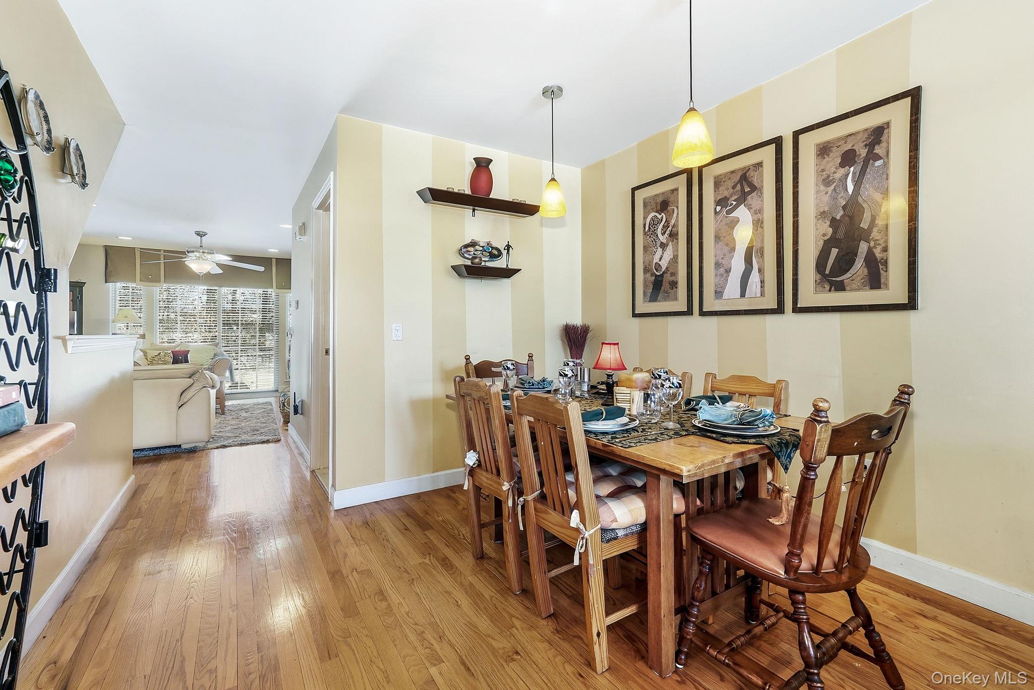 1604 Pondview Loop Wappingers Falls, NY 12590 - Photo 12 of 37 a view of a dining area with furniture wooden floor and a chandelier