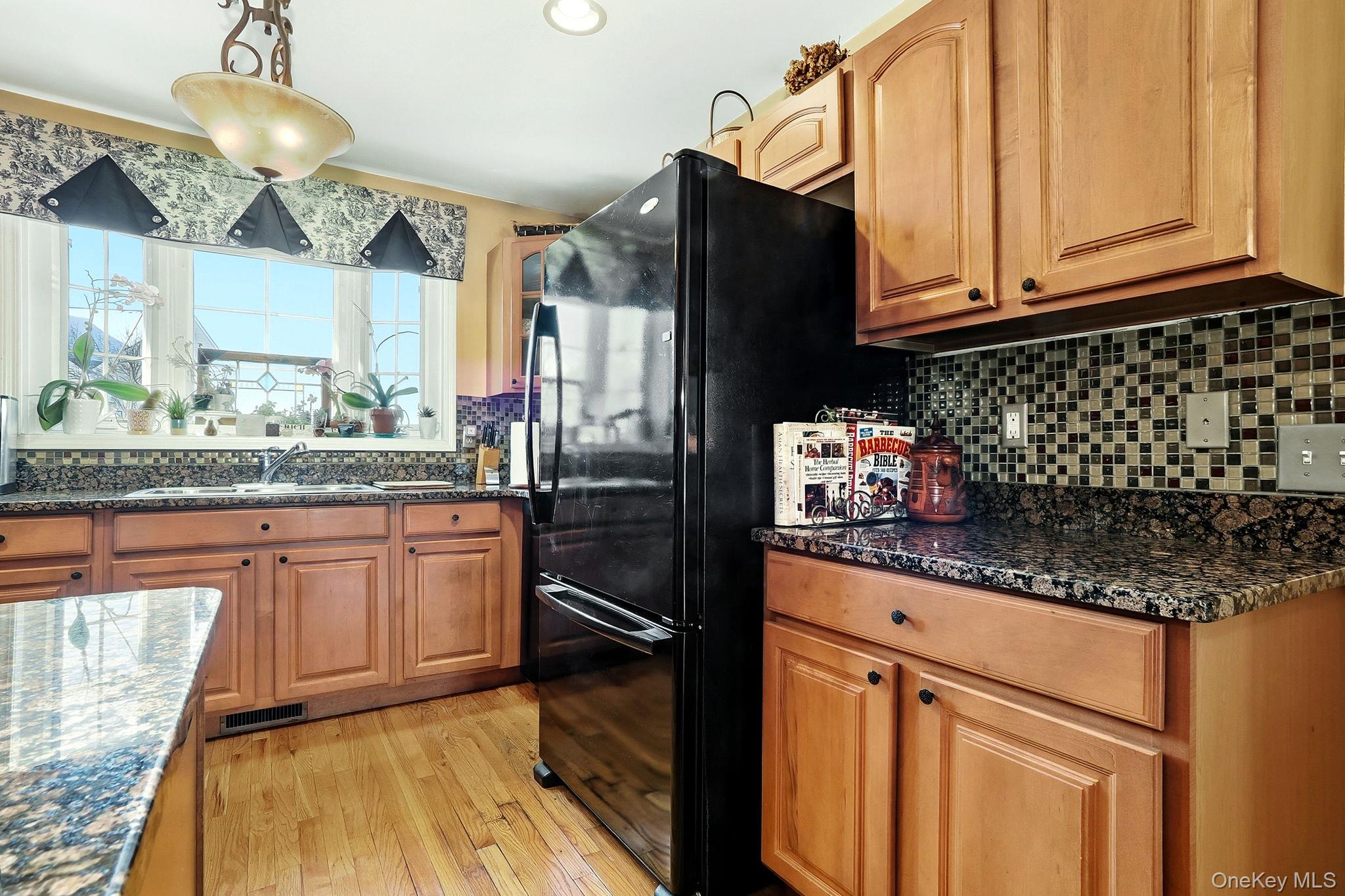 1604 Pondview Loop Wappingers Falls, NY 12590 - Photo 14 of 37 a kitchen with granite countertop stainless steel appliances a sink stove and refrigerator