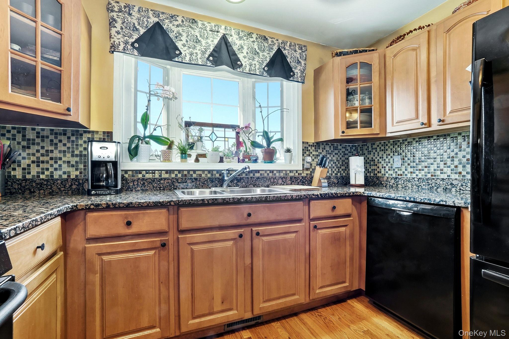 1604 Pondview Loop Wappingers Falls, NY 12590 - Photo 17 of 37 a kitchen with stainless steel appliances granite countertop a sink and cabinets