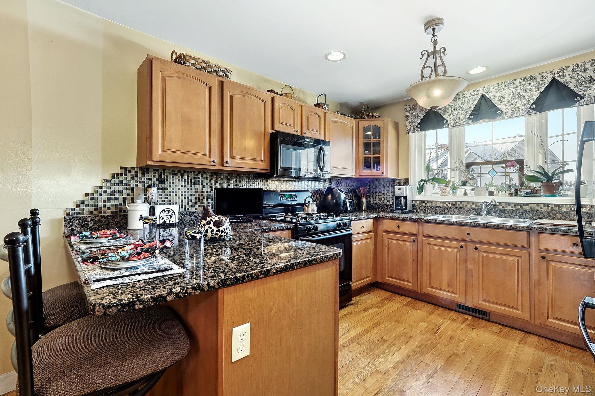 1604 Pondview Loop Wappingers Falls, NY 12590 - Photo 18 of 37 a kitchen with stainless steel appliances granite countertop a sink stove and cabinets