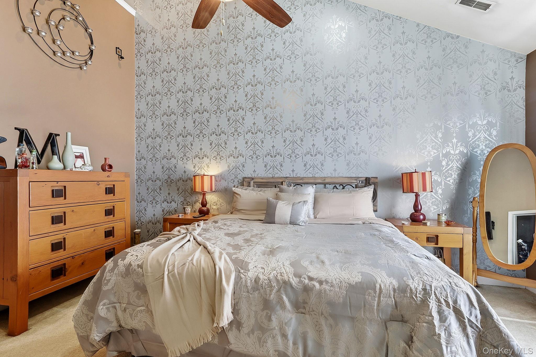 1604 Pondview Loop Wappingers Falls, NY 12590 - Photo 20 of 37 a bedroom with a bed and a chandelier