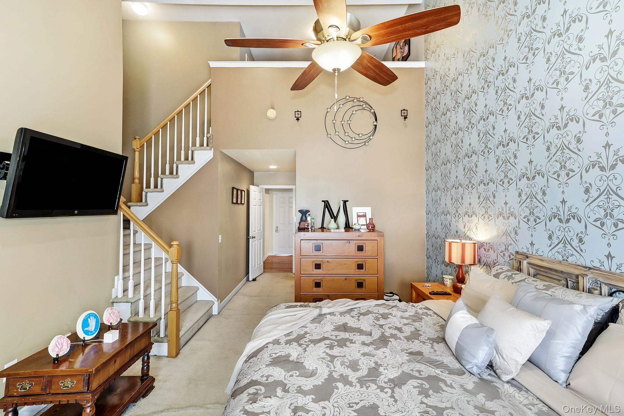 1604 Pondview Loop Wappingers Falls, NY 12590 - Photo 21 of 37 a bedroom with a bed and a chandelier