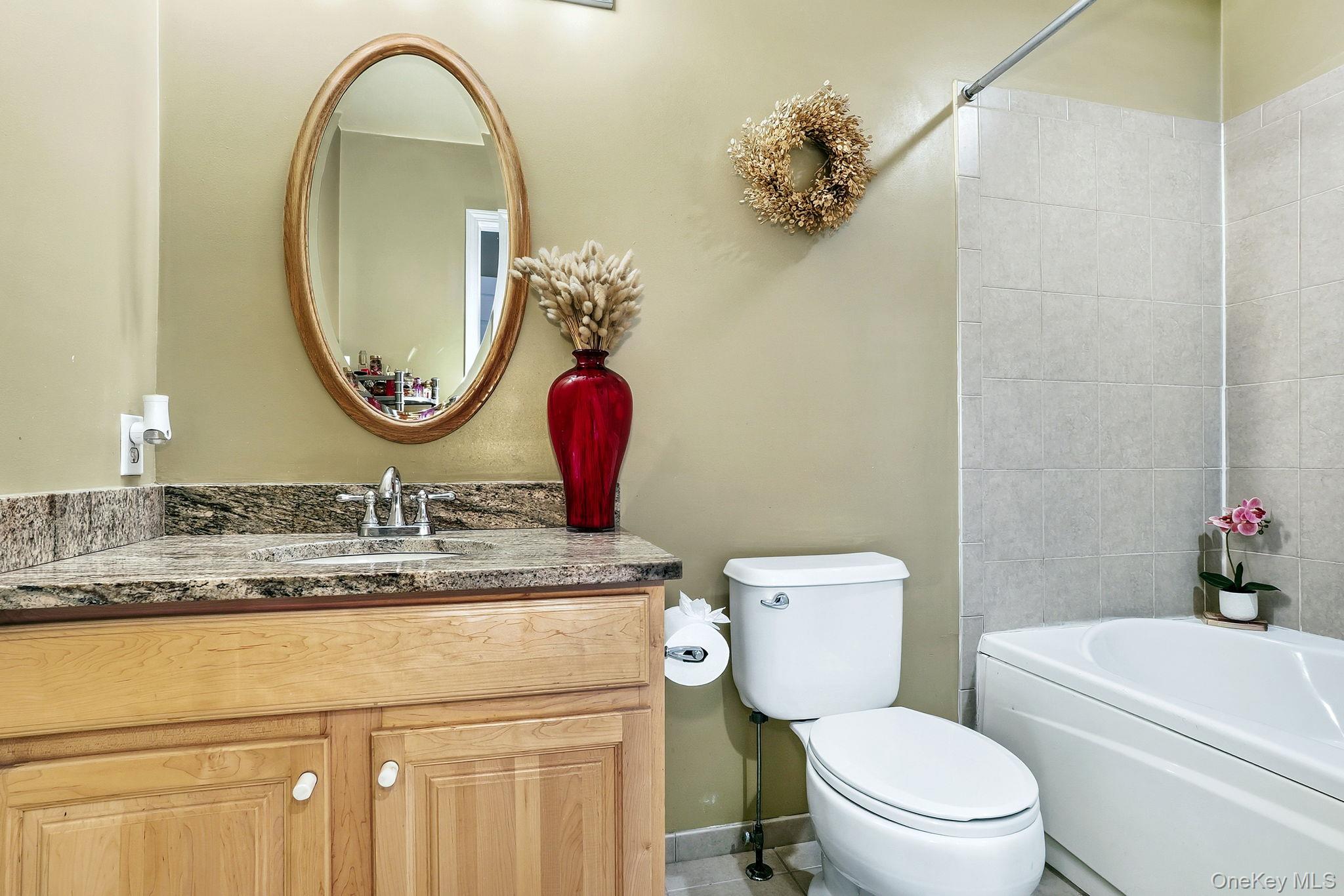 1604 Pondview Loop Wappingers Falls, NY 12590 - Photo 23 of 37 a bathroom with a toilet a sink and a mirror
