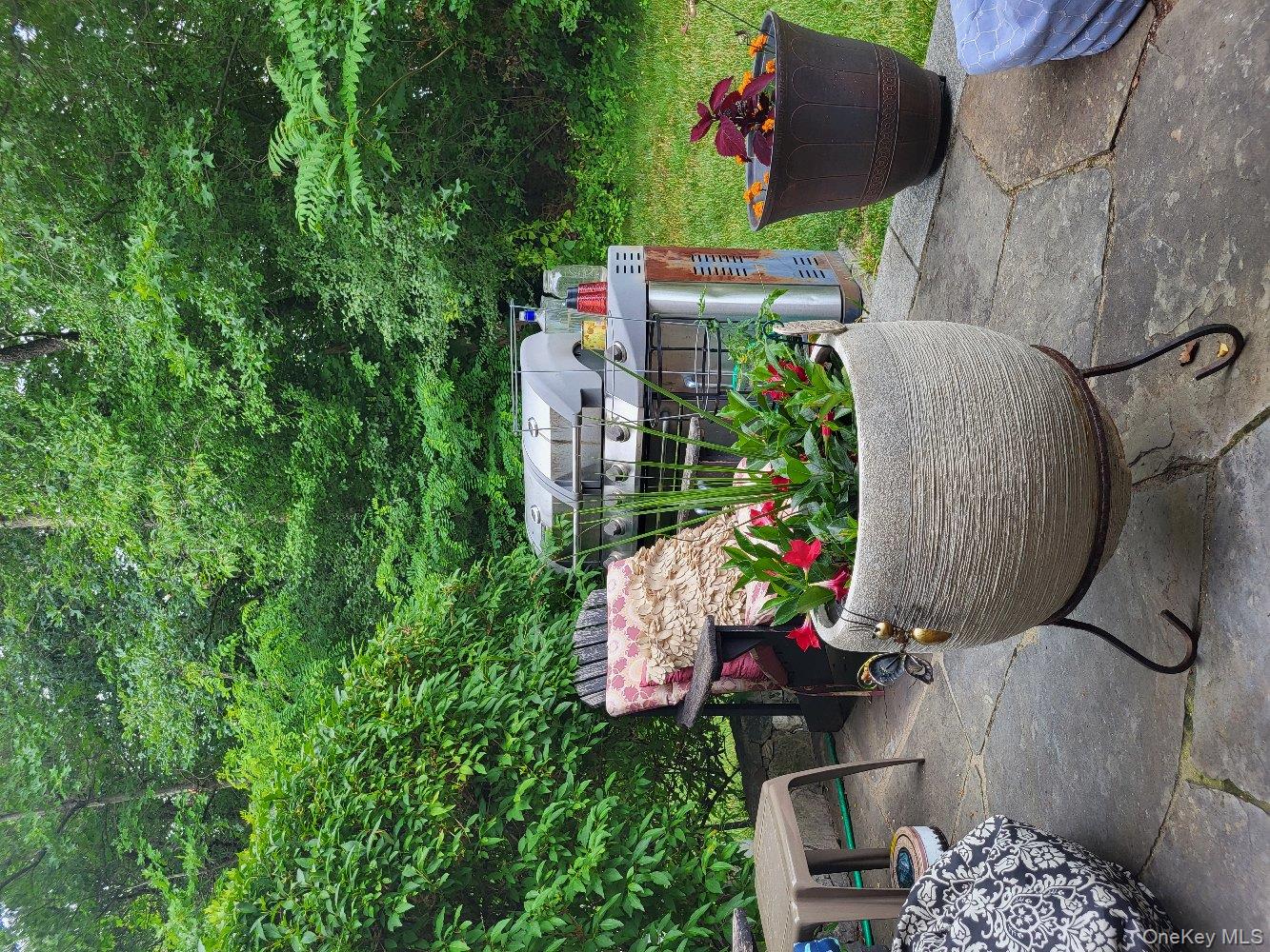 1604 Pondview Loop Wappingers Falls, NY 12590 - Photo 27 of 37 a view of a backyard with garden and sitting area