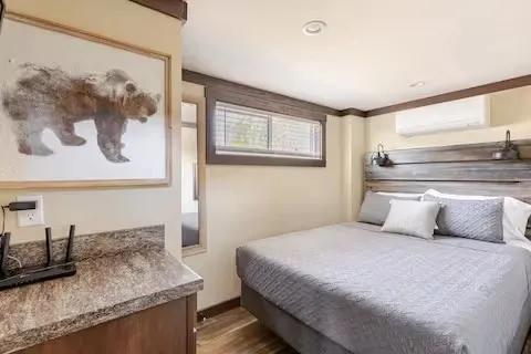 a bedroom with a bed and the painting on the wall