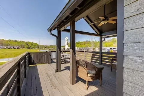 a view of a balcony with wooden floor and outdoor seating