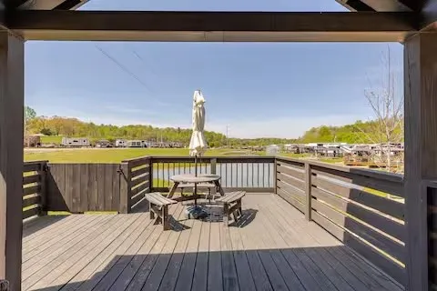 a view of a balcony with wooden floor and outdoor seating