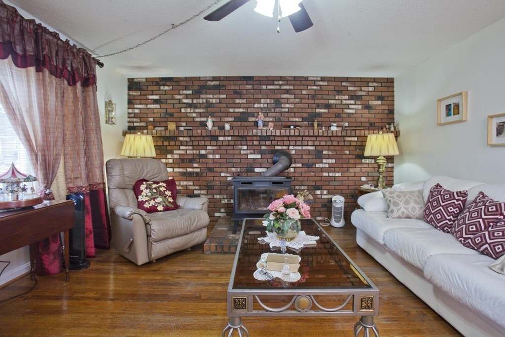 267 Shawmut Street Springfield, MA 01108 - Photo 11 of 30 a living room with furniture and a fireplace