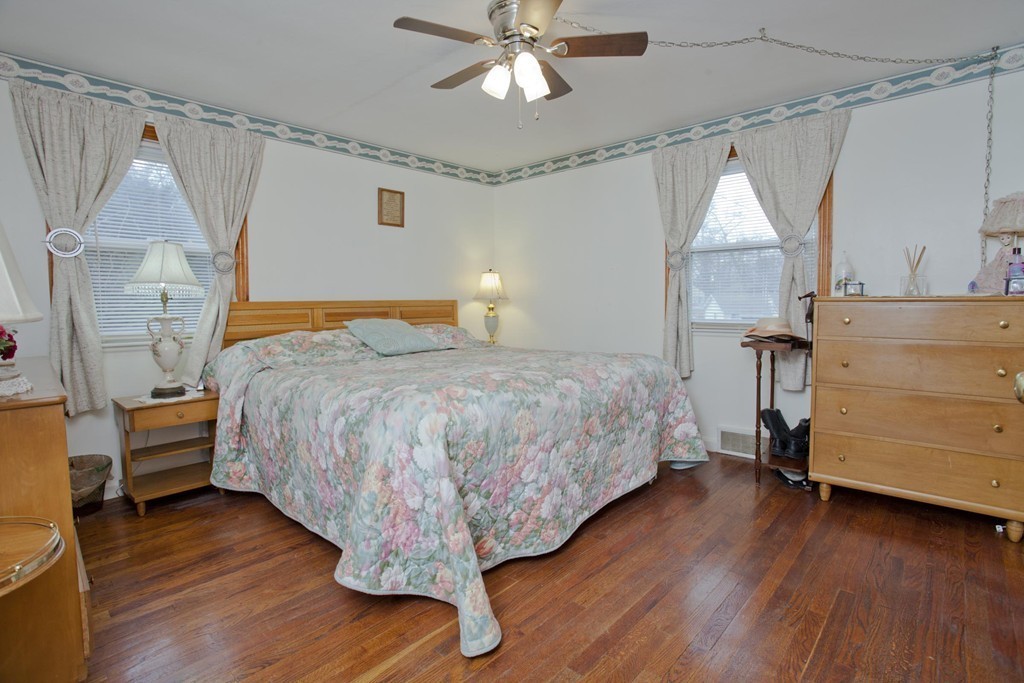267 Shawmut Street Springfield, MA 01108 - Photo 18 of 30 a bedroom with a bed and a chandelier