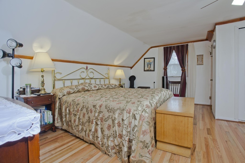 267 Shawmut Street Springfield, MA 01108 - Photo 20 of 30 a bedroom with a bed and wooden floor