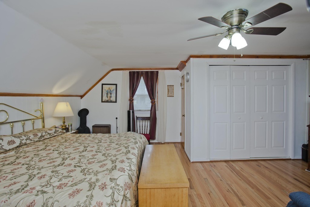 267 Shawmut Street Springfield, MA 01108 - Photo 21 of 30 a bed room with a bed and a ceiling fan
