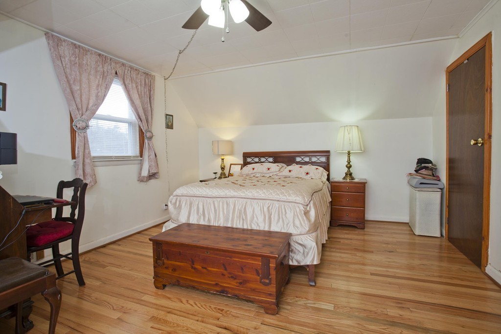 267 Shawmut Street Springfield, MA 01108 - Photo 24 of 30 a bedroom with a bed windows and a chandelier