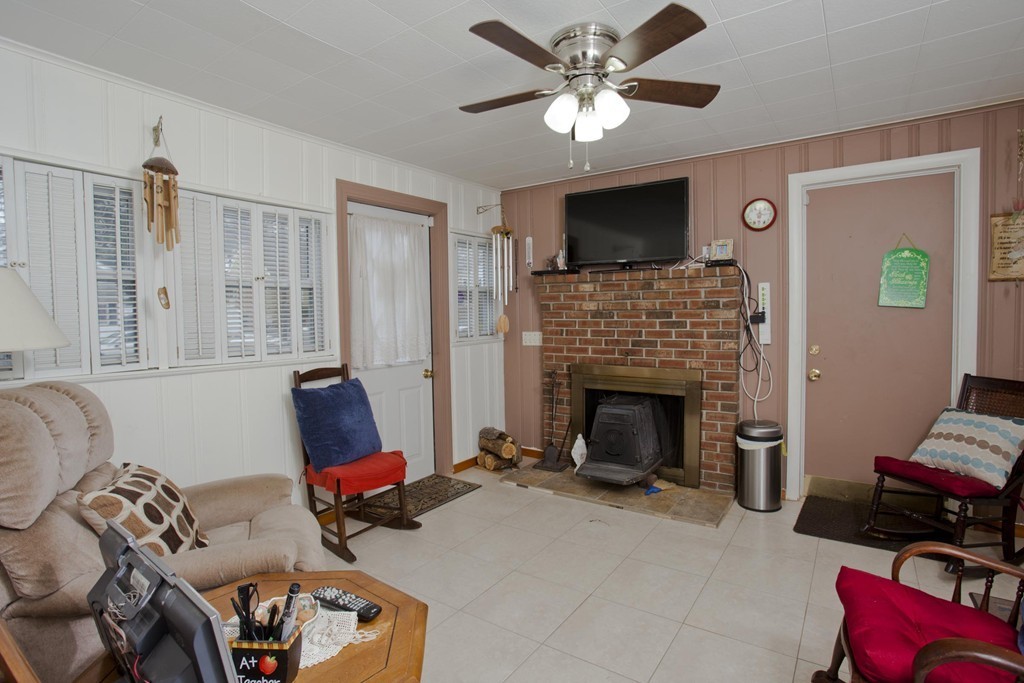 267 Shawmut Street Springfield, MA 01108 - Photo 5 of 30 a living room with furniture and a fireplace