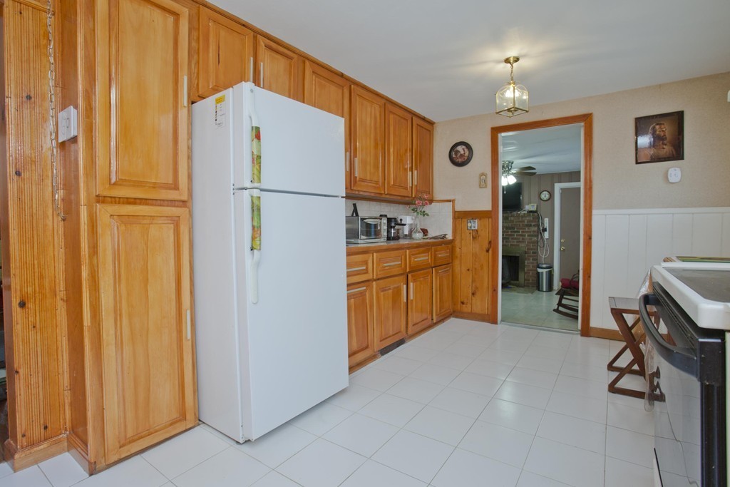 267 Shawmut Street Springfield, MA 01108 - Photo 9 of 30 a kitchen with stainless steel appliances a refrigerator and cabinets