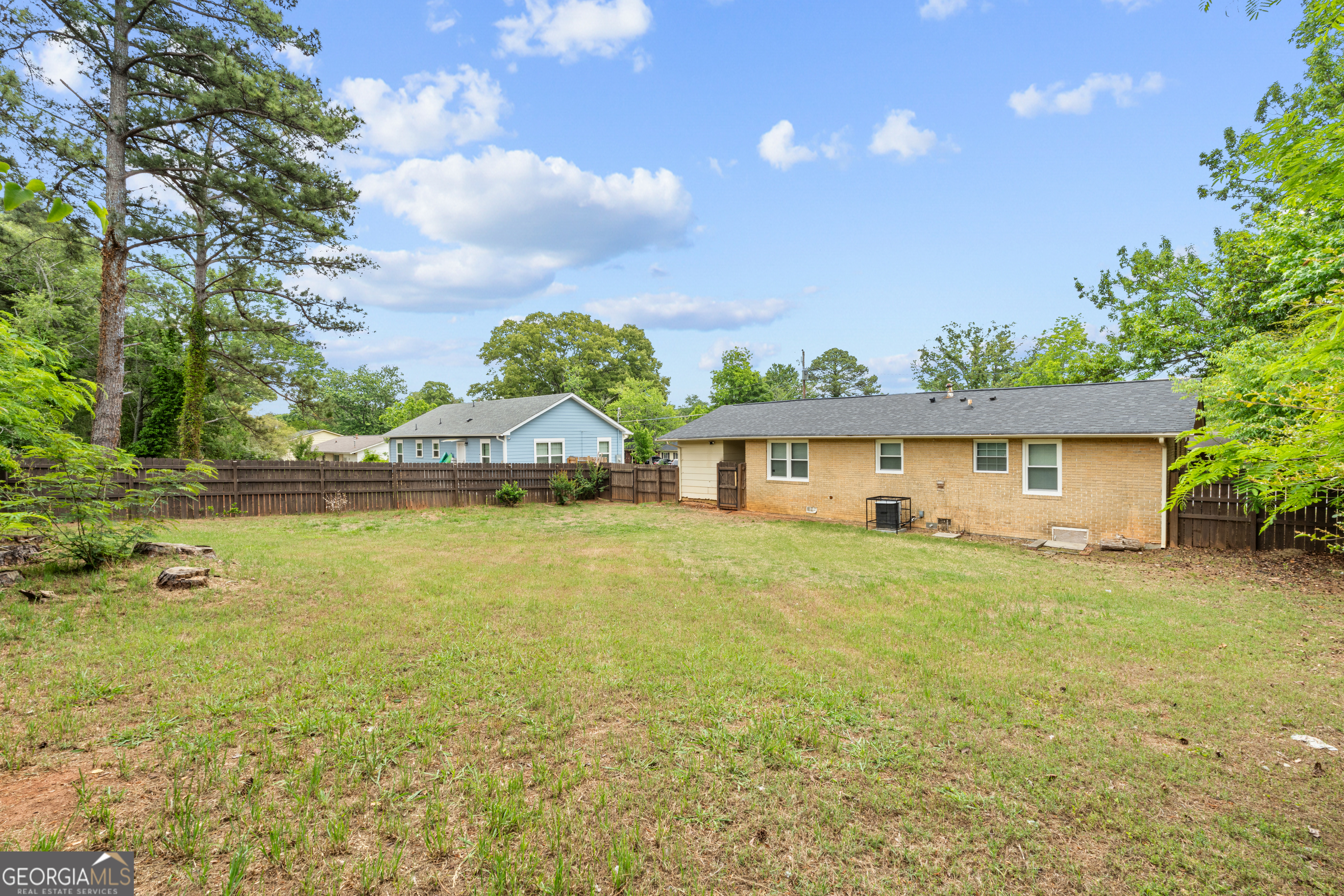 2161 Rochelle Way South Fulton, GA 30349 - Photo 20 of 20 a front view of a house with a garden and deck