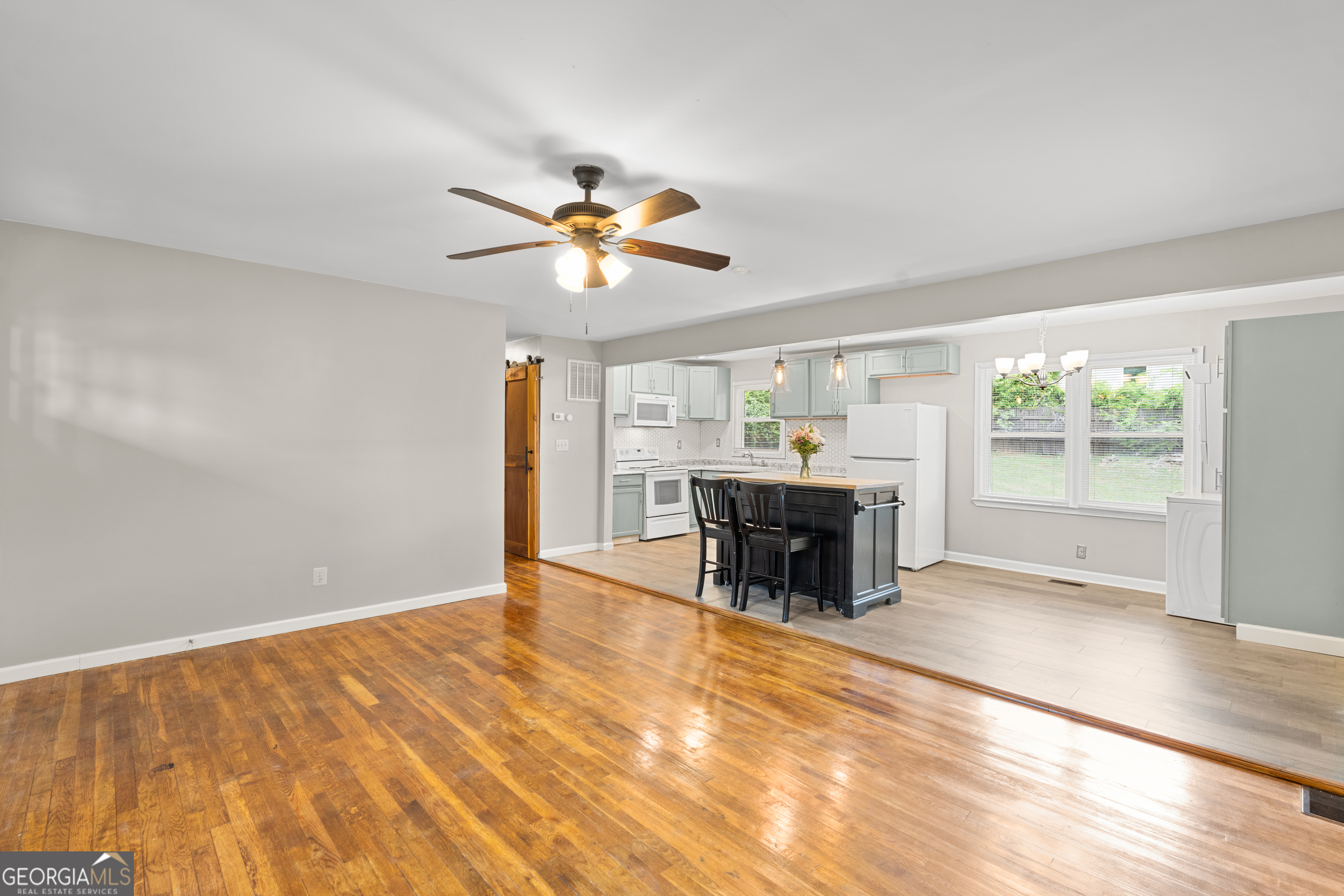 2161 Rochelle Way South Fulton, GA 30349 - Photo 3 of 20 an empty room with fireplace and chandelier fan