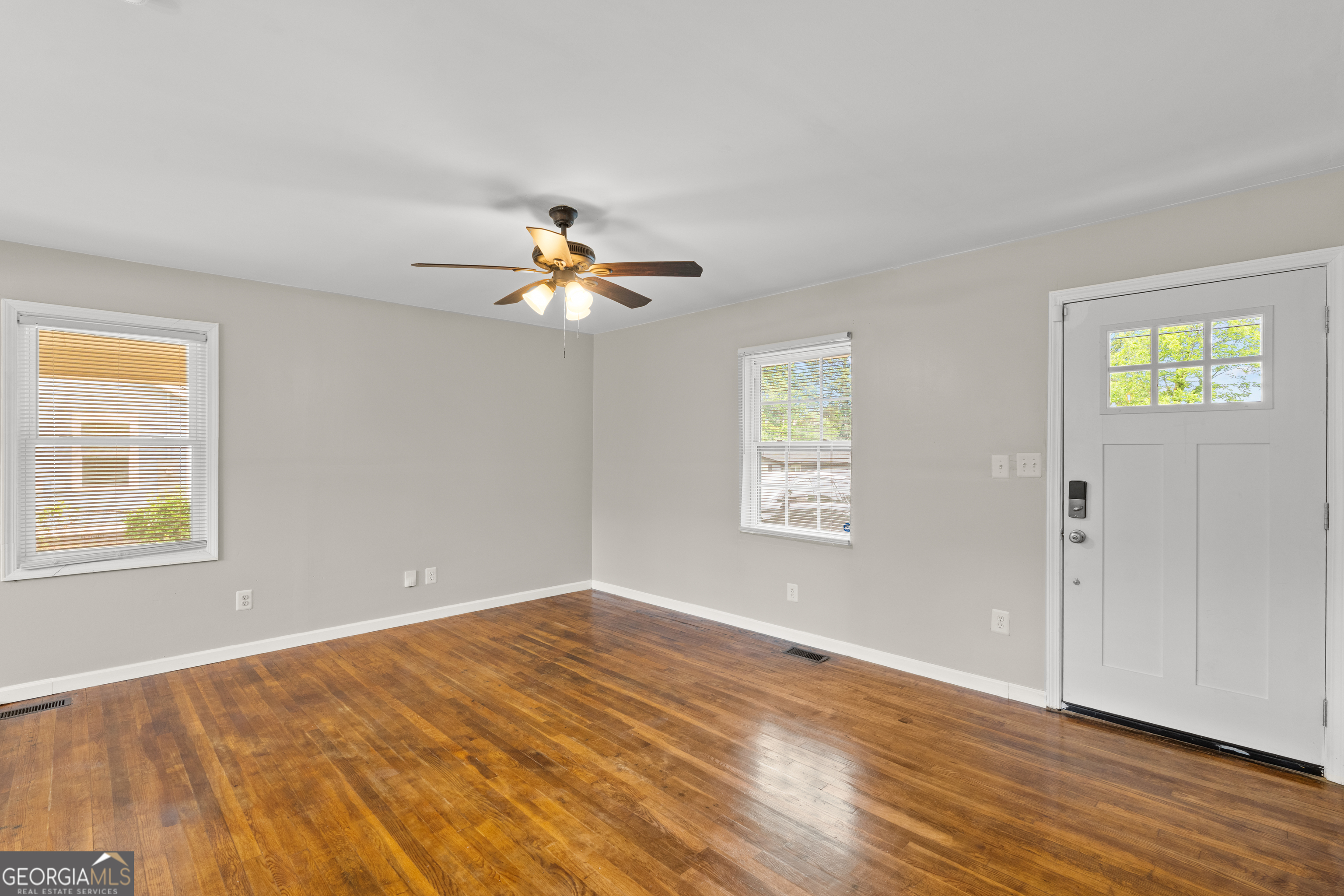 2161 Rochelle Way South Fulton, GA 30349 - Photo 4 of 20 a view of an empty room with wooden floor and a window