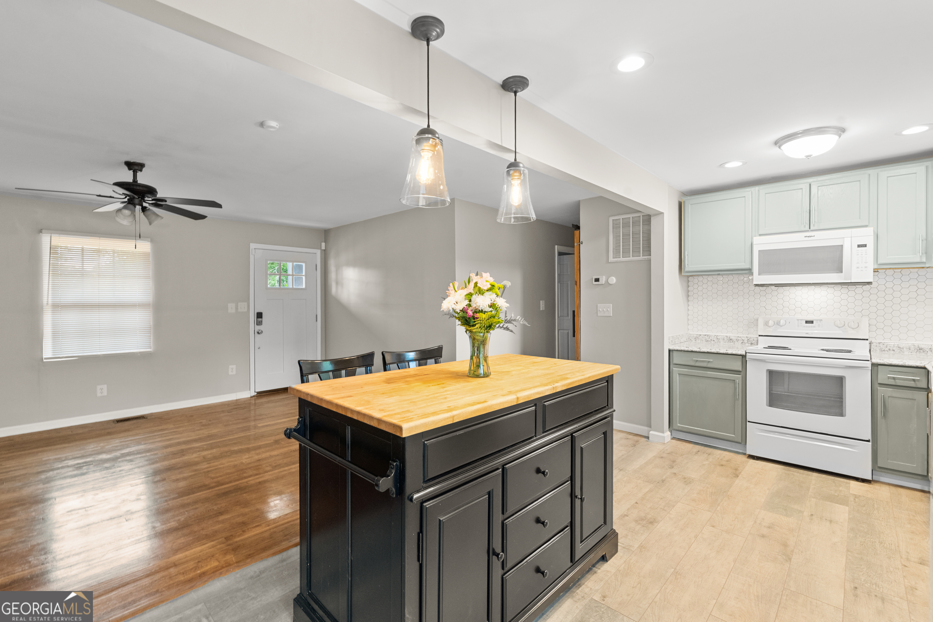 2161 Rochelle Way South Fulton, GA 30349 - Photo 6 of 20 a kitchen with a stove chandelier and wooden floor