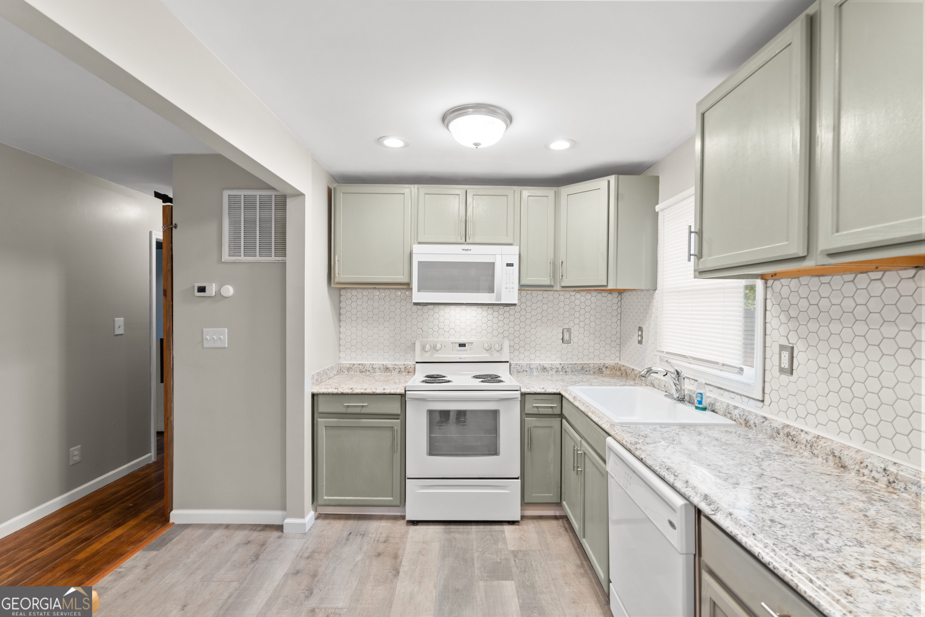 2161 Rochelle Way South Fulton, GA 30349 - Photo 8 of 20 a kitchen with a stove sink and cabinets