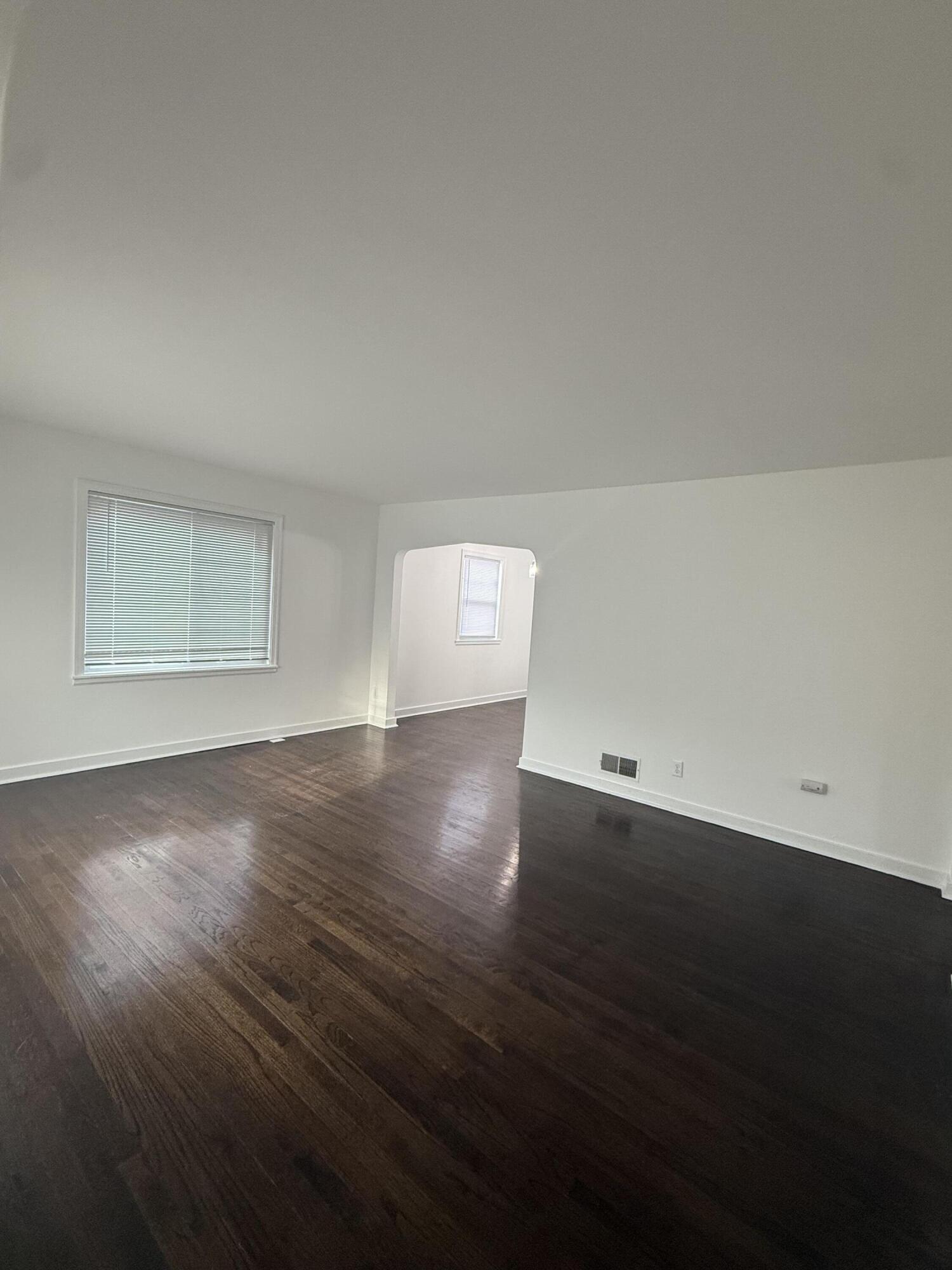 541 Chase Street Gary, IN 46404 - Photo 3 of 13 a view of an empty room with wooden floor and a window