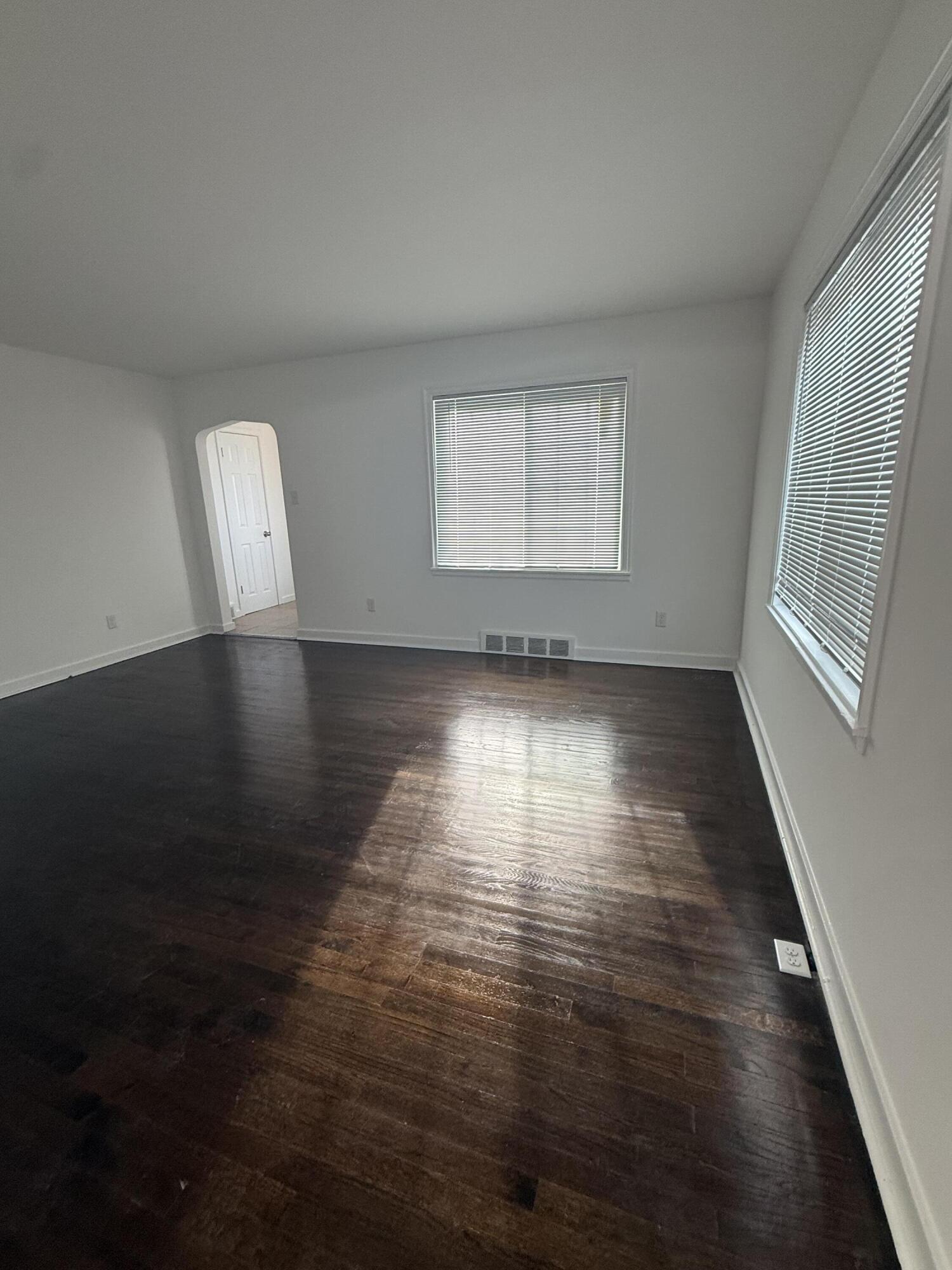 541 Chase Street Gary, IN 46404 - Photo 4 of 13 an empty room with wooden floor and windows
