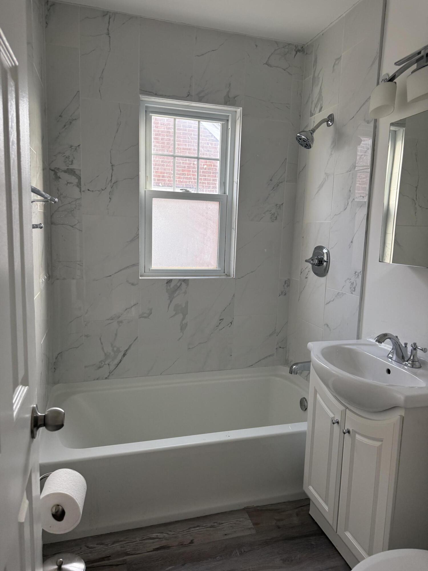 541 Chase Street Gary, IN 46404 - Photo 5 of 13 a bathroom with a tub a sink and a shower