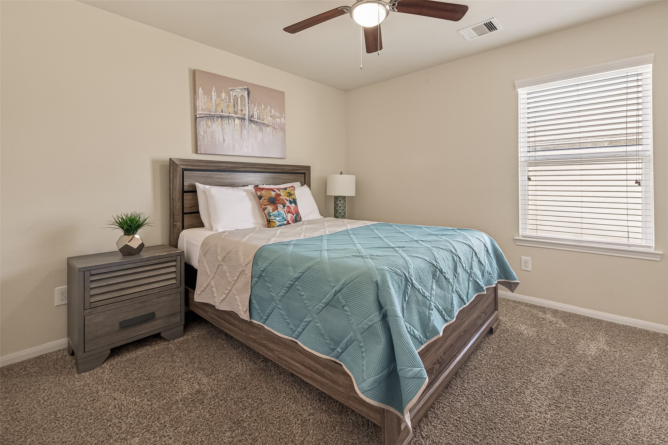 4508 Coopers Hl Trail Rosenberg, TX 77471 - Photo 30 of 43 a bed sitting in a bedroom next to a window and a chandelier